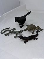 Photo showing all four metal animal figurines together on a white backdrop.