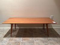 Front view showing the entire rectangular coffee table with tapered legs and wooden top.