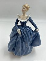 Front-left view of Royal Doulton "Fragrance" figurine showing detailed flowing blue dress and hairstyle.