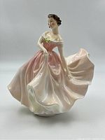 Front view of the Royal Doulton The Polka figurine, showing detailed facial features, pink dress with floral detail, and flowing skirt.
