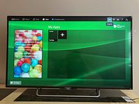 Front view of Sony Bravia TV powered on, displaying smart TV interface with apps on screen.