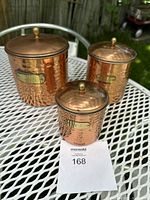 Three vintage copper canisters labeled tea, coffee, and sugar, showing their full size and detail.
