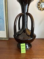 Front view of the large mid century vase showing tall neck, rounded body, and four curved handles attached.