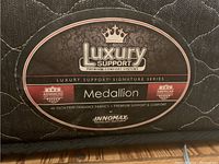 Close-up of mattress label showing Innomax Luxury Support Medallion branding