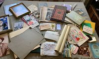 Overview of the entire collection showing a variety of items including books, papers, photographs, and some postcards.
