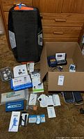 Wide view of all health devices including large vibration plate and various smaller boxed and loose devices.