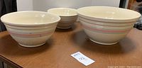 Three McCoy nesting stoneware bowls together, showing size difference and design