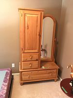 Full front view of the pine armoire showing cupboard, drawers, and hinged mirror.