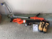 Full lot showing trimmer, blower, charger, battery, and boots