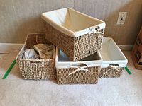 Four wicker baskets stacked and arranged, showing sizes and cotton liners with bows.