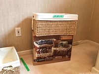 Photo of the largest wicker basket sitting on top of the original unopened box, showing size and packaging