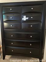 Front view of high boy dresser showing six small upper drawers, narrow middle drawer, and three lower drawers.