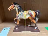 Front view of Native Dancer horse figure with intricate painted decoration and base