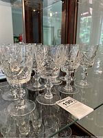 Set of 8 clear crystal goblets with pinwheel cut design on shelf