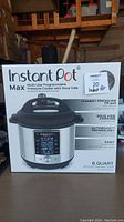Image of the Instant Pot Max 6 Quart in its original box showing front branding and features.