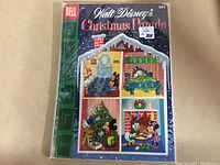 Photo of 1955 Walt Disney's Christmas Parade Dell Giant comic book showing front cover inside protective plastic wrap.