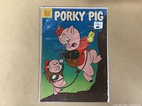 Front cover photo of 1956 Porky Pig comic book issue #46 in protective plastic showing cover art and label indication.