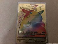 Photo of a Pikachu VMAX holographic rainbow foil Pokémon card with gold border and 310 HP, card number 064/094.