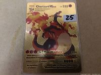 Front close-up of the Charizard VMAX gold Pokemon card showing details, HP, and attack information