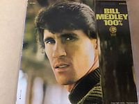 Front cover of Bill Medley 100% vinyl LP showing the artist portrait with yellow text and MGM Records logo.