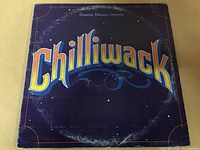 Front cover of Chilliwack 'Dreams, Dreams, Dreams' vinyl LP showing band title and worn edges.