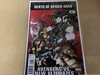 Front cover of Death of Spider-Man #1 comic book showing Avengers vs New Ultimates battle scene.
