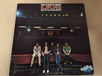 Front cover of The Guess Who Live at the Paramount gatefold vinyl LP showing band members in front of a theater stage.