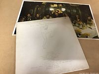 Vinyl LP cover art showing minimal drawing with track listing and included band poster behind cover.