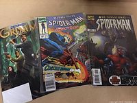 Photo of three comics: Grimm, Marvel Tales Spider-Man Ghost Rider, and The Sensational Spider-Man.