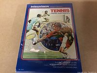 Front view of sealed Intellivision Tennis game box featuring player artwork and scoreboard illustration
