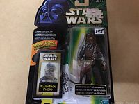 Vintage Star Wars Hoth Chewbacca action figure on original card with attached bowcaster rifle and flashback photo insert in original packaging.