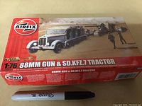 Photo showing the front top view of the sealed vintage Airfix 1:76 scale model kit box featuring the 88mm gun and Sd.Kfz.7 tractor with a Sharpie marker beside it for size reference.