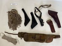 Five leather holsters and accessories laid out showing sizes, colors, and conditions.