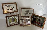 All five beer mirrors arranged on display showing size and condition.