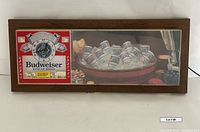 Front view showing full bar light and clock with Budweiser branding.