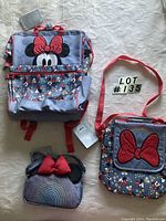 Full lot showing three bags on white textured background with tags and lot number