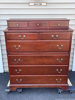 Full front view showing the entire dresser with removable glove box on top, wood finish and brass handles.