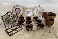 Photo showing full collection of soup crocks, teak salad bowls, metal baking bowls, glass dessert dishes, pie plates and metal cookbook stand.