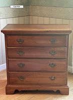 Front view of Harden cherry wood chest showing four drawers with brass handles and dovetail joinery.