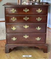 Front view of Harden chest showing four drawers with brass handles and key escutcheons, solid cherry wood and dovetail joinery visible.
