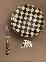 Top view of cake plate and cake server side by side on flat surface with lot number visible.