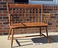 Side view of vintage 2-person bench showing solid maple hardwood construction, spindle back, and angled legs.