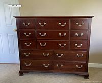 Front view of full chest showing all 13 drawers and hardware