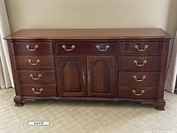 Full frontal view of dresser showing serpentine profile, drawers and doors
