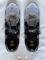 Full view of both Tubbs snow shoes from top showing bindings and frame detail.