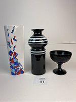 Front view of three items: Aldo Londi Bitossi vase, Memphis Milano wall pocket, and black glass compote.