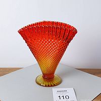 Front view of amberina glass fan vase showing color gradient and hobnail diamond texture.
