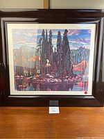 Full view of framed print leaning on table