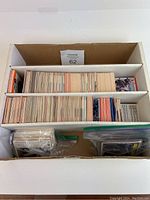 Box with large quantity of assorted trading cards, packed in sections
