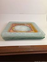 Side view of stacked fused glass plates showing thickness and layered glass construction.